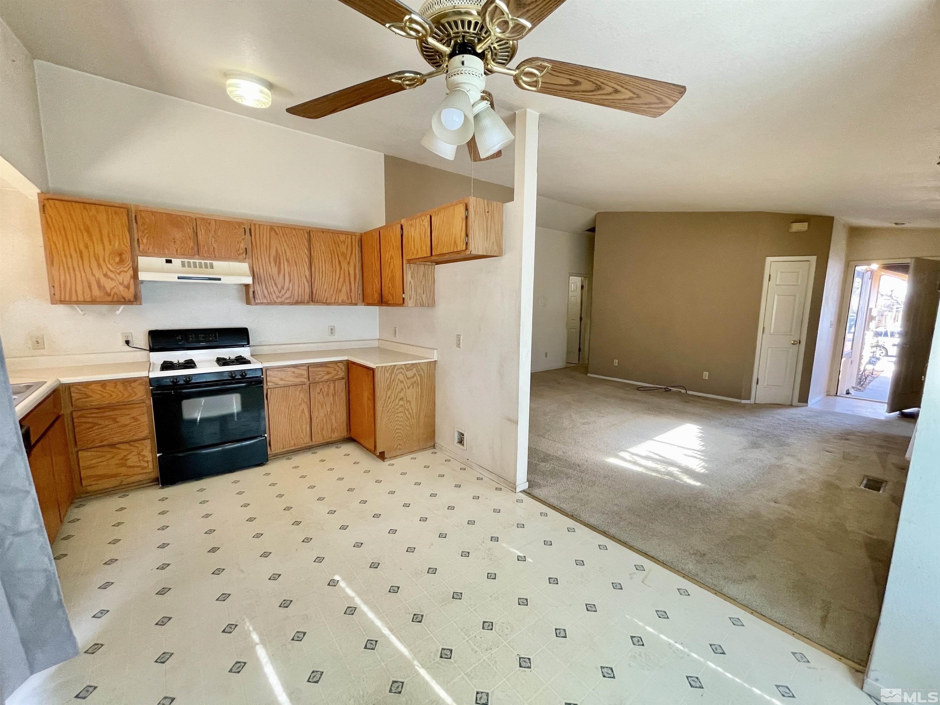 6930 Flower Street Reno, NV 89506 - Photo 7 of 19 a kitchen with stainless steel appliances a stove a sink a refrigerator and cabinets