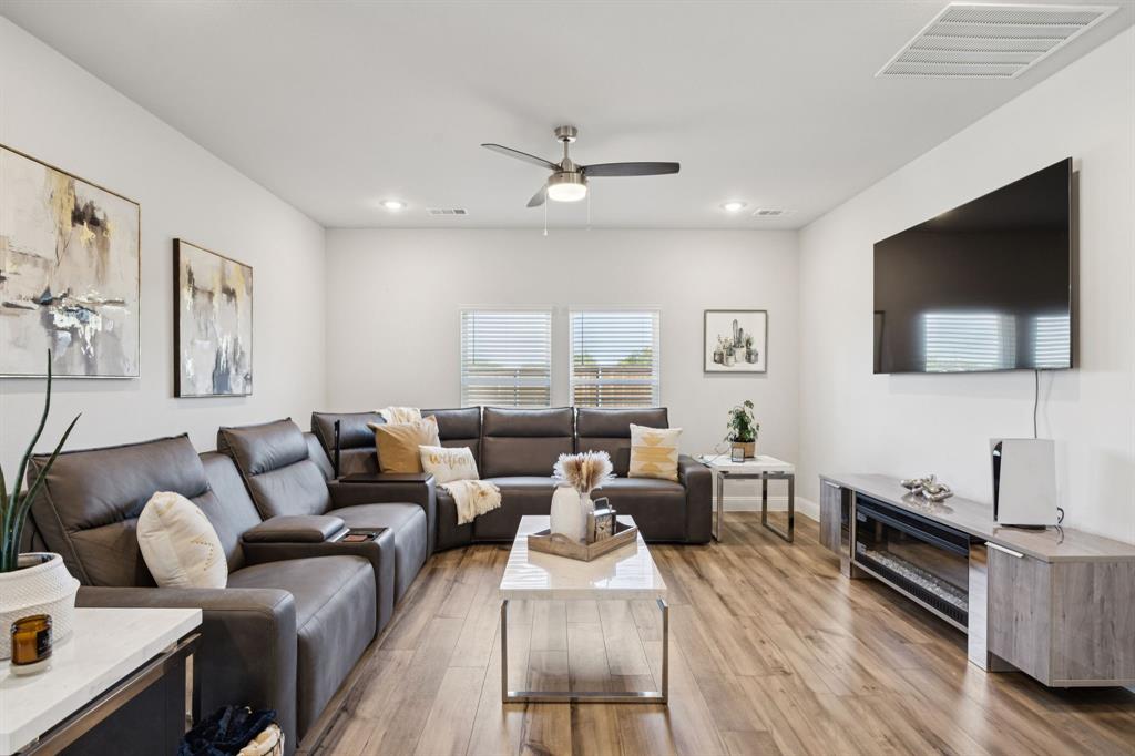 722 Cari Lane Forney, TX 75126 - Photo 11 of 40 a living room with furniture and a flat screen tv