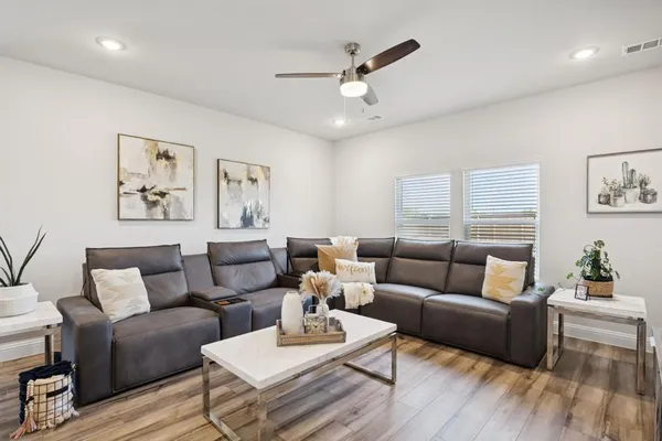 a living room with furniture and wooden floor