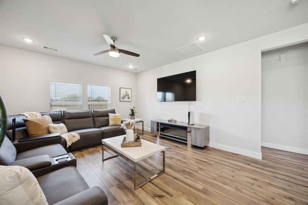 722 Cari Lane Forney, TX 75126 - Photo 13 of 40 a living room with furniture and a flat screen tv
