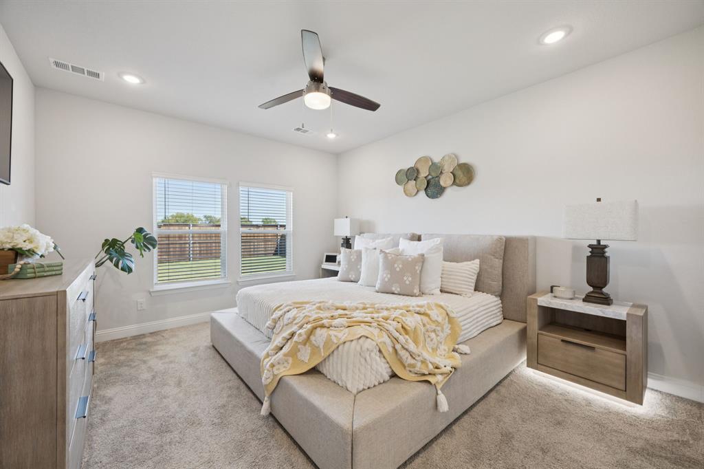 722 Cari Lane Forney, TX 75126 - Photo 14 of 40 a bedroom with a large bed and a window