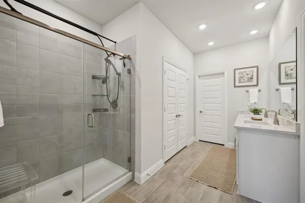 a bathroom with a shower and a sink
