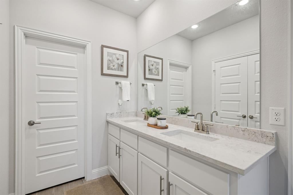 722 Cari Lane Forney, TX 75126 - Photo 18 of 40 a bathroom with a sink and a mirror