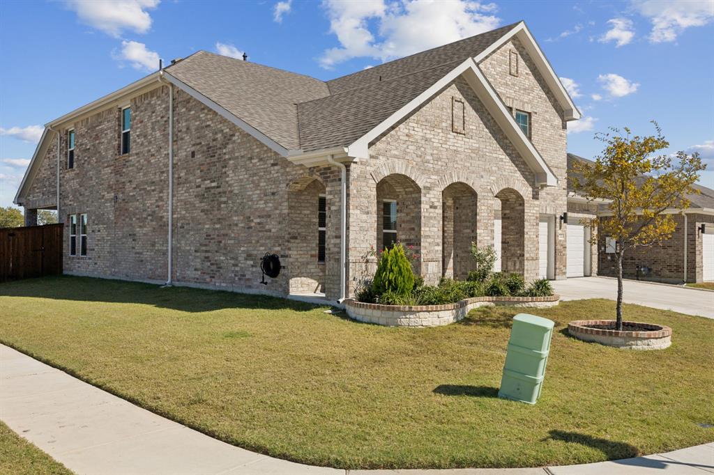 722 Cari Lane Forney, TX 75126 - Photo 2 of 40 a front view of a house with garden