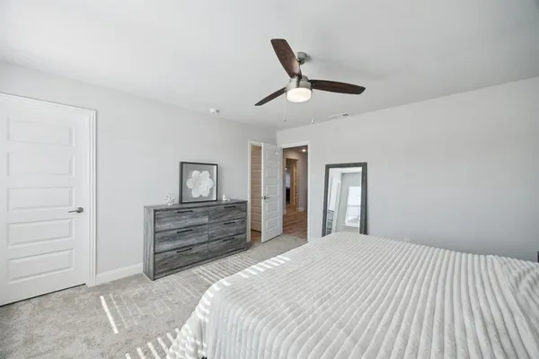 a bedroom with a bed and a dresser