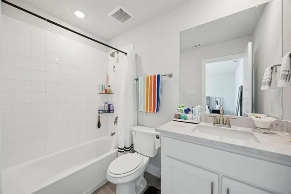 a bathroom with a sink toilet tub and shower