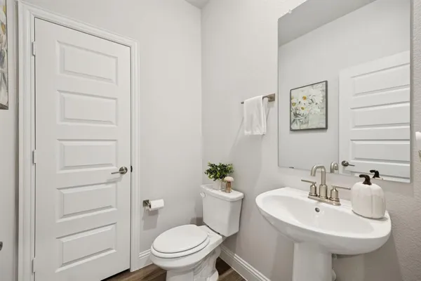 a bathroom with a sink toilet and a mirror