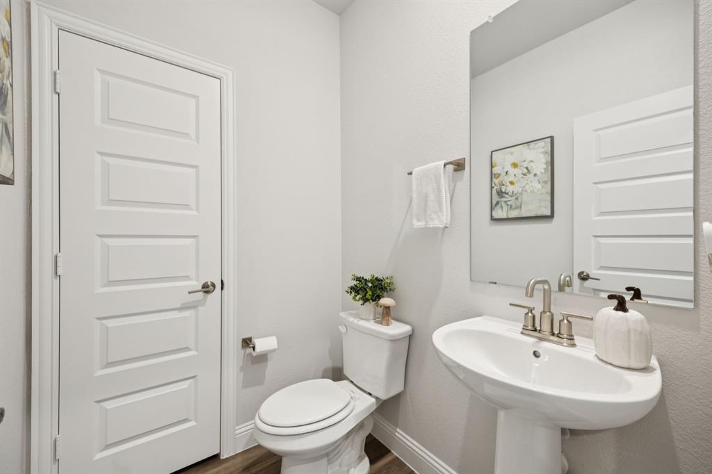 722 Cari Lane Forney, TX 75126 - Photo 32 of 40 a bathroom with a sink toilet and a mirror