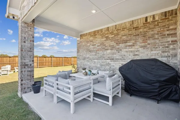 a outdoor living space with furniture and a fireplace