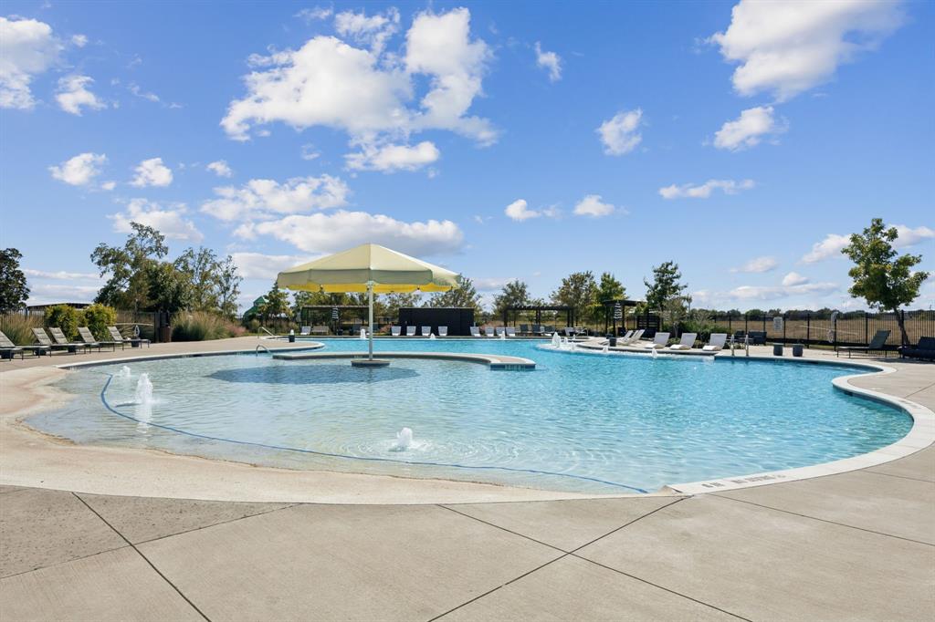 722 Cari Lane Forney, TX 75126 - Photo 37 of 40 a view of a swimming pool with an outdoor space and seating in back