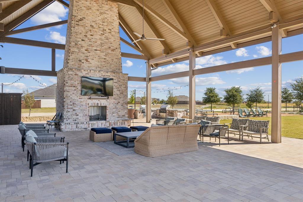 722 Cari Lane Forney, TX 75126 - Photo 39 of 40 a living room with fireplace furniture and a floor to ceiling window