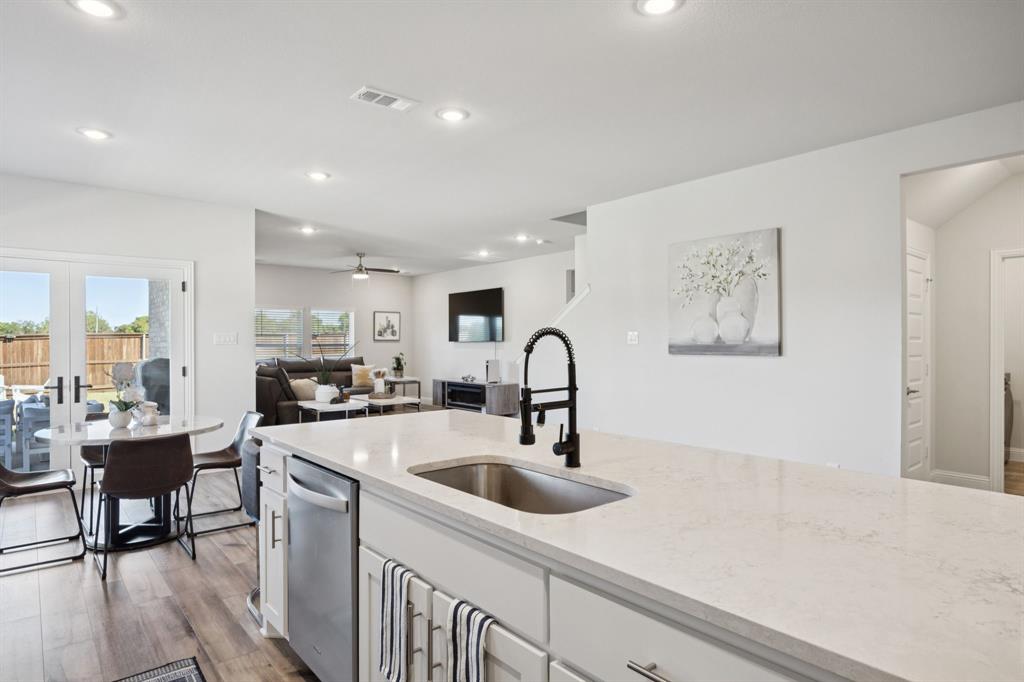 722 Cari Lane Forney, TX 75126 - Photo 9 of 40 a kitchen with counter top space a sink cabinets and appliances