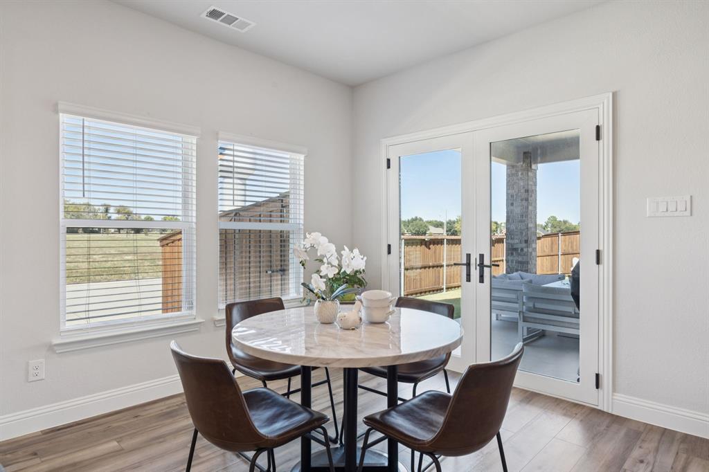 722 Cari Lane Forney, TX 75126 - Photo 10 of 40 a view of a dining room with furniture and wooden floor
