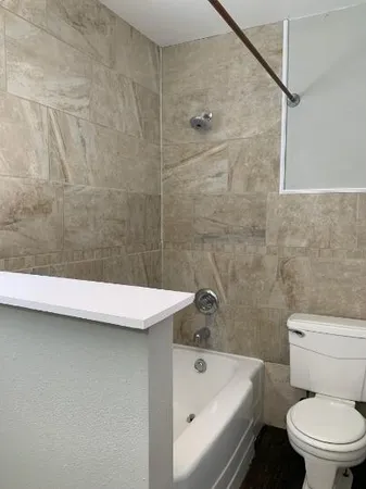 a bathroom with a sink a toilet and bathtub
