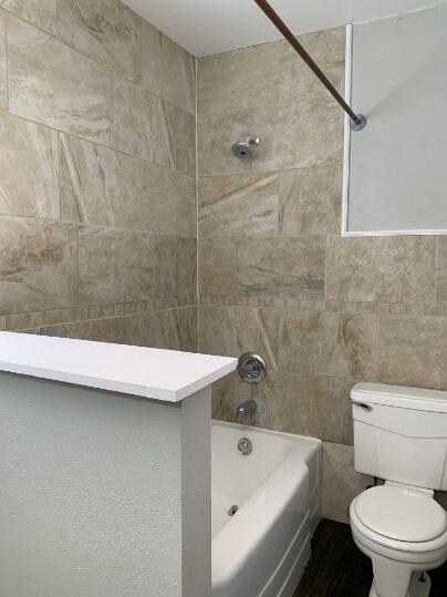 3807 26th Street Lubbock, TX 79410 - Photo 13 of 19 a bathroom with a sink a toilet and bathtub