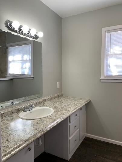 3807 26th Street Lubbock, TX 79410 - Photo 16 of 19 a bathroom with a granite countertop sink and a mirror