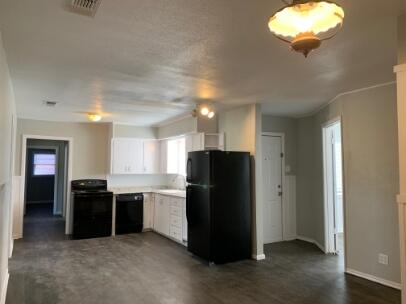 3807 26th Street Lubbock, TX 79410 - Photo 2 of 19 a kitchen with stainless steel appliances granite countertop a refrigerator and a sink