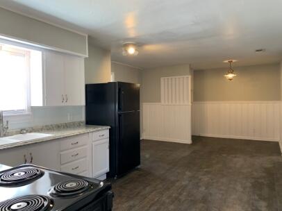 3807 26th Street Lubbock, TX 79410 - Photo 3 of 19 a kitchen with a stove and a refrigerator