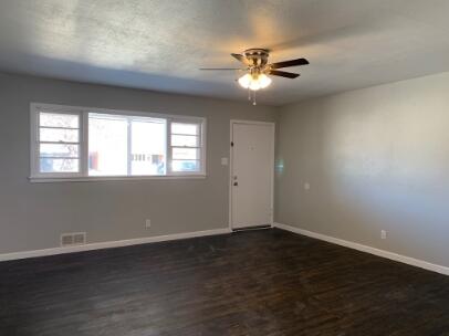 3807 26th Street Lubbock, TX 79410 - Photo 8 of 19 a view of an empty room with wooden floor and a window