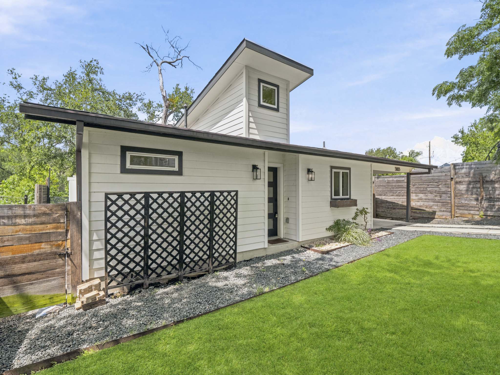 5005 Lott Avenue, Unit 2 Austin, TX 78721 - Photo 21 of 25 A striking contemporary residence boasts clean lines, a gabled roof, and a meticulously landscaped exterior.