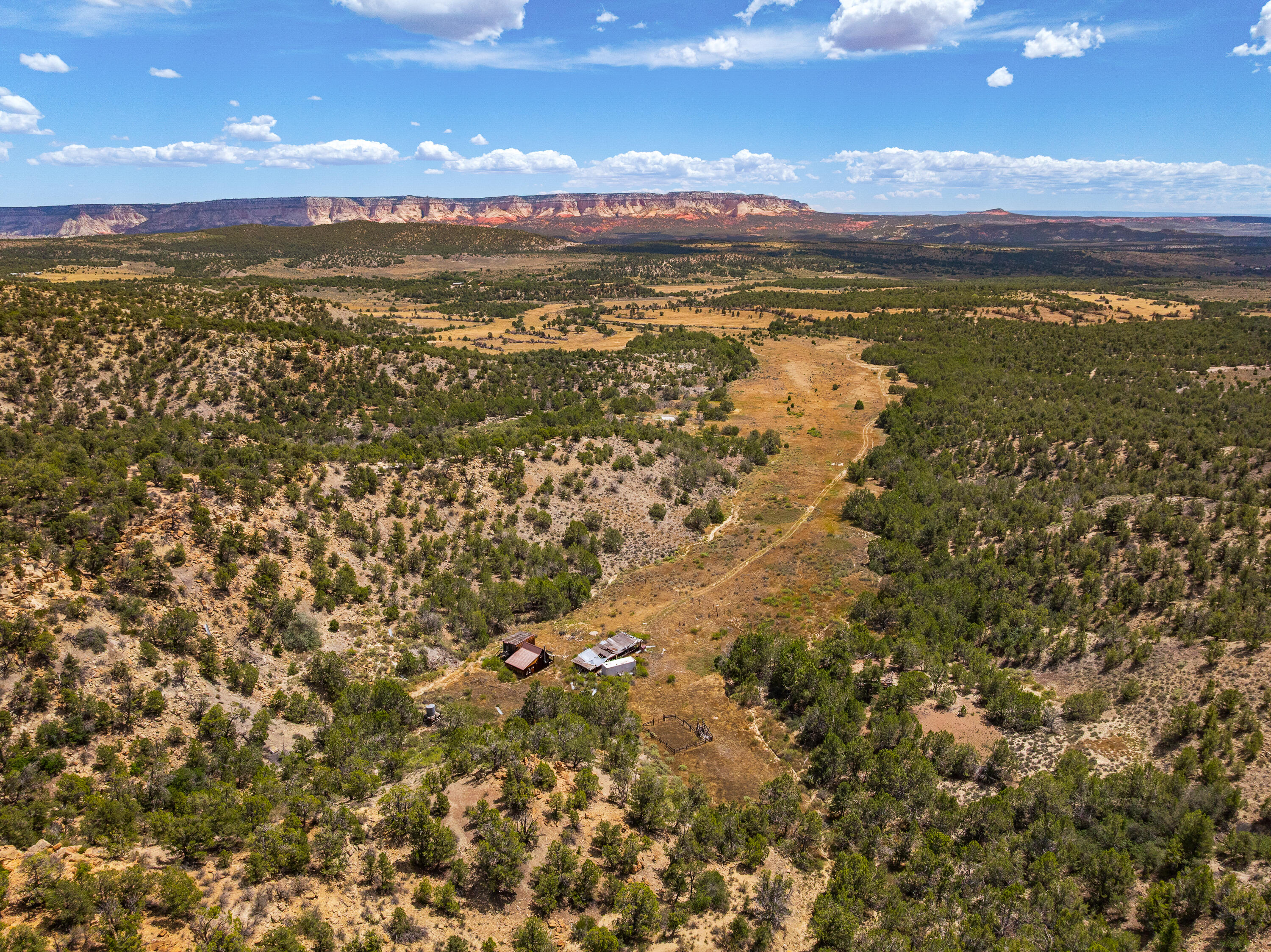 Rusty Nail Ranch Mount Carmel, UT 84755 - Photo 14 of 25 Headquarters complex in the drainage, East Zion on the horizon. Ranch road visible running north to the buildings