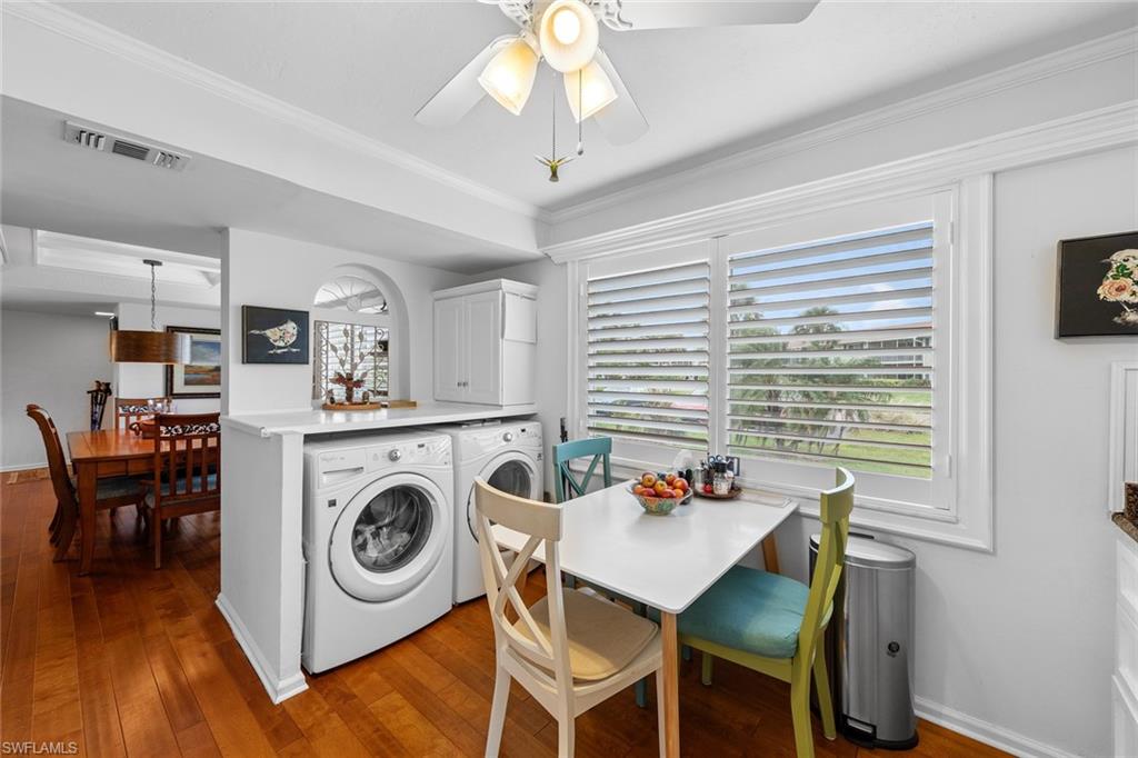 287 Albi Road, Unit 2803 Naples, FL 34112 - Photo 15 of 50 Dining space with ceiling fan, wood-type flooring, crown molding, and separate washer and dryer