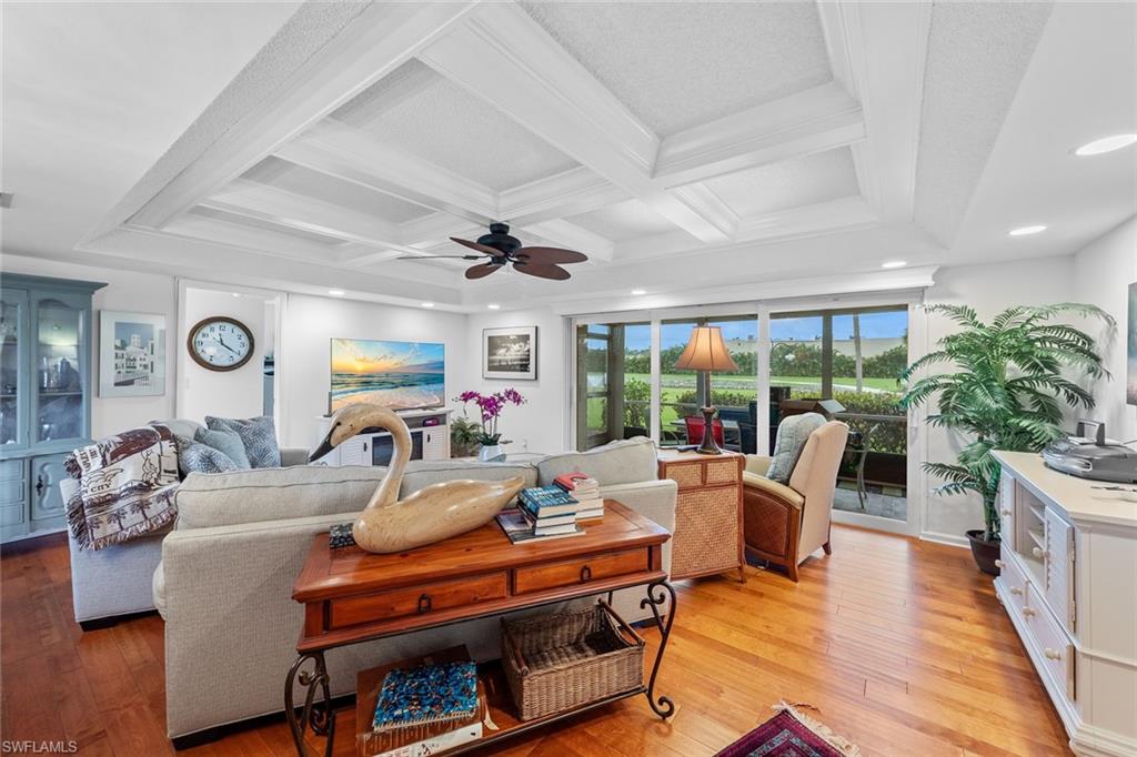 287 Albi Road, Unit 2803 Naples, FL 34112 - Photo 9 of 50 Living room with ceiling fan, beam ceiling, light wood-type flooring, and coffered ceiling