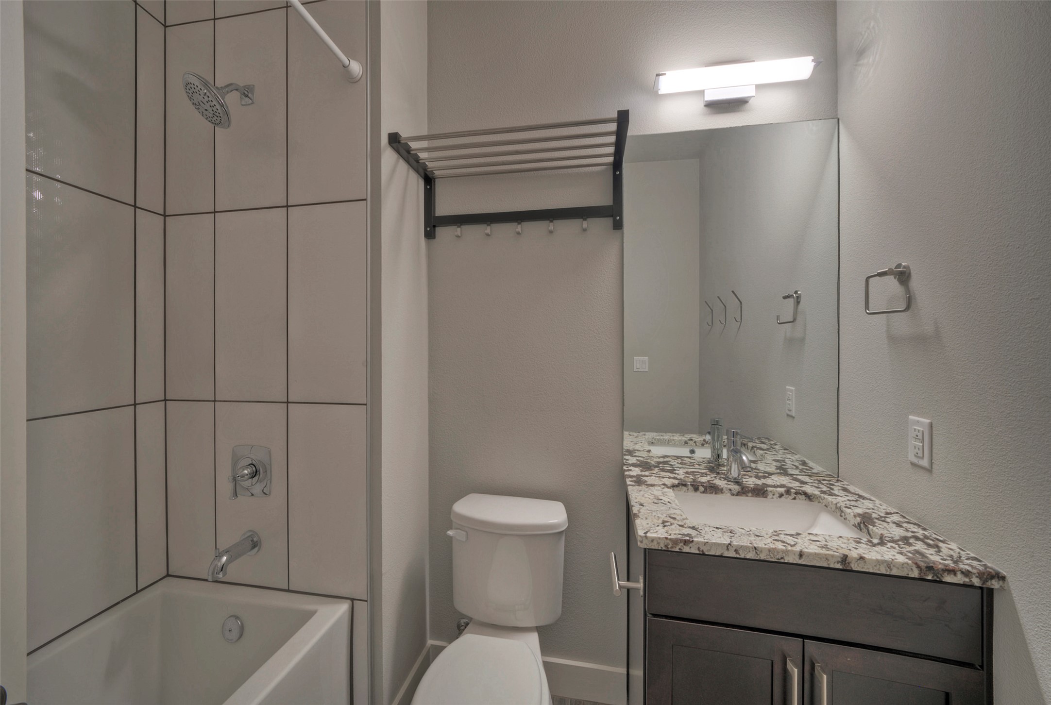 8110 Southeast Ranch Road 2222, Unit 98 Austin, TX 78730 - Photo 18 of 31 Clean lines define this modern bathroom with its tiled shower and stone countertop vanity.