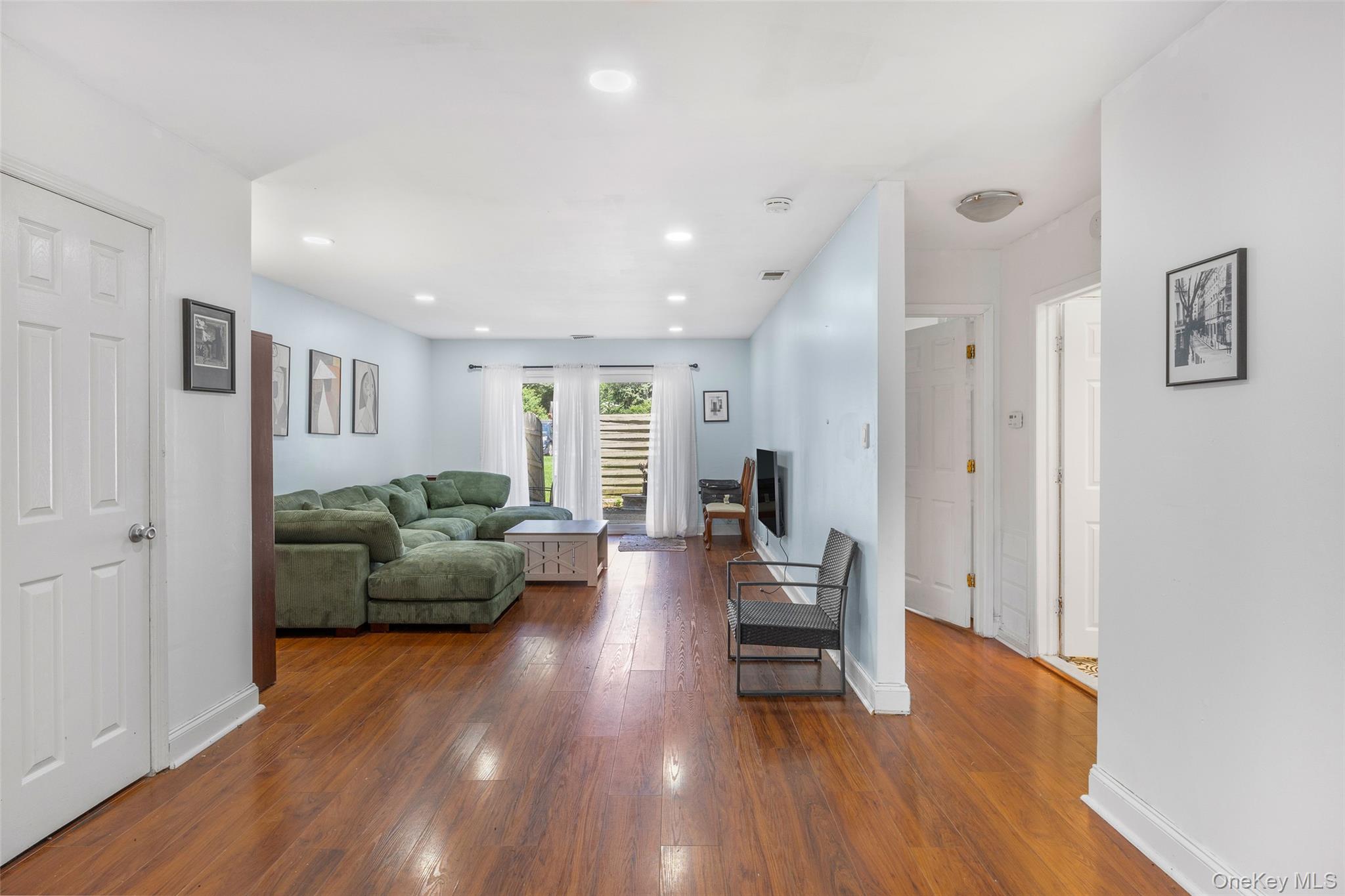 655 Middle Country Road, Unit 1G1 Coram, NY 11727 - Photo 4 of 15 a living room with furniture and a wooden floor