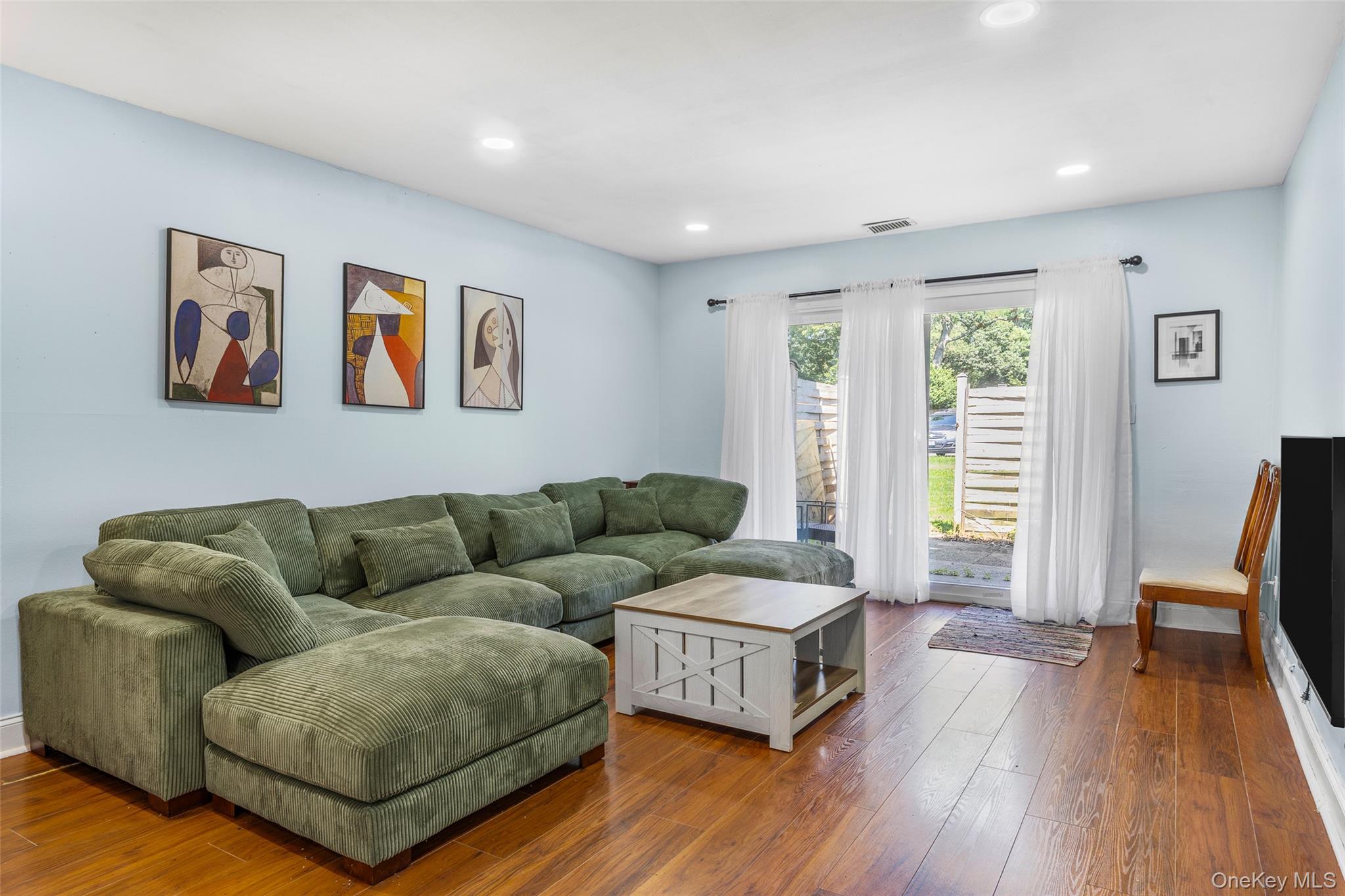 655 Middle Country Road, Unit 1G1 Coram, NY 11727 - Photo 6 of 15 a living room with furniture and a wooden floor