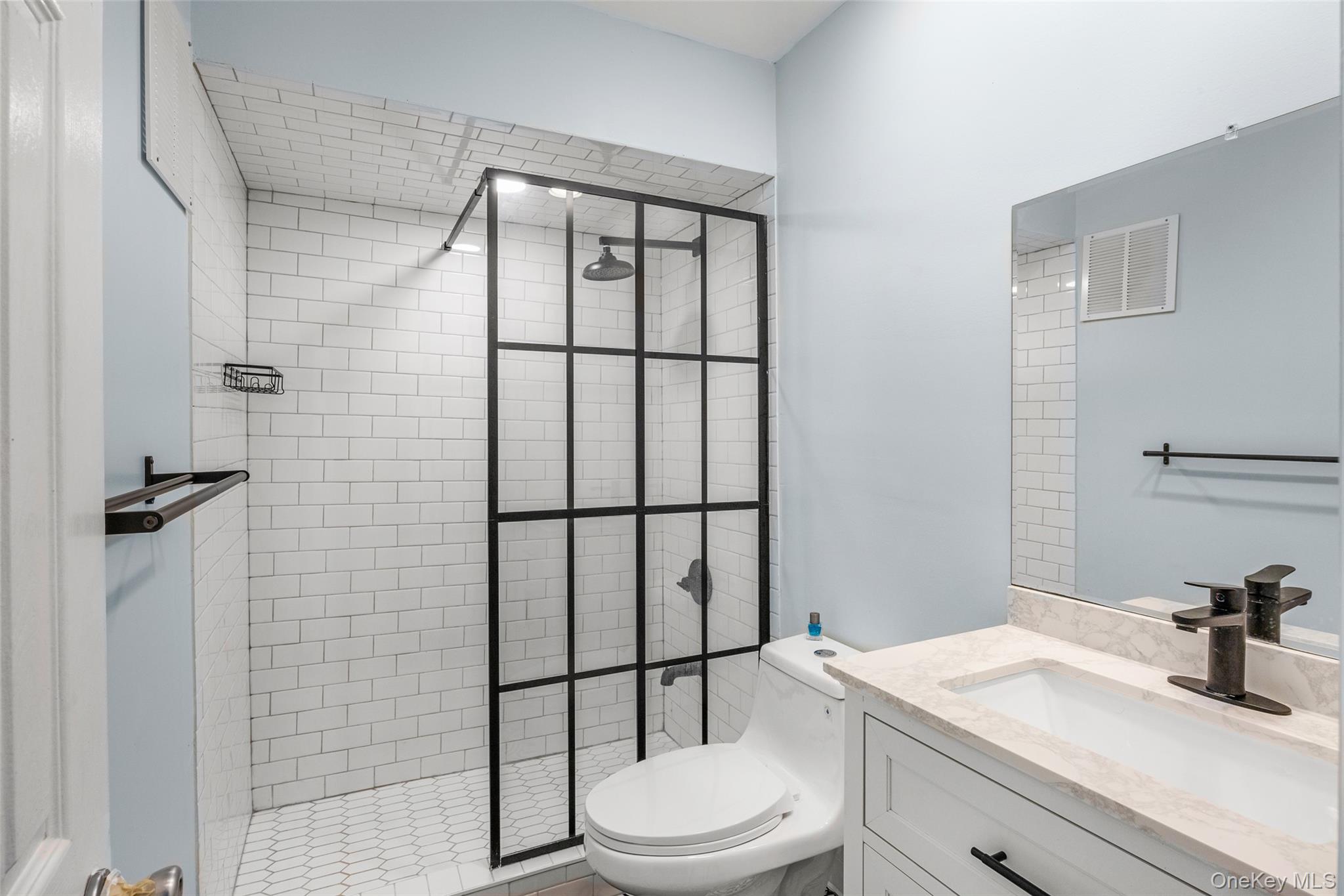 655 Middle Country Road, Unit 1G1 Coram, NY 11727 - Photo 7 of 15 a bathroom with a sink toilet and shower