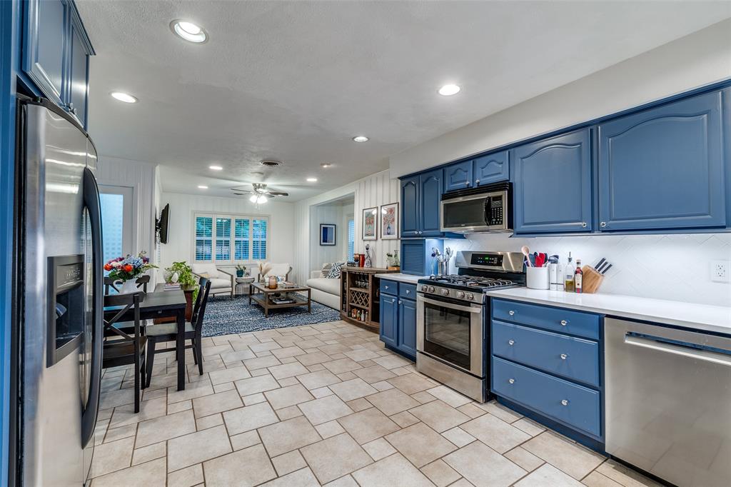4159 Clover Lane Dallas, TX 75220 - Photo 24 of 25 Kitchen with stainless steel appliances, blue cabinetry, recessed lighting, light countertops, and open floor plan