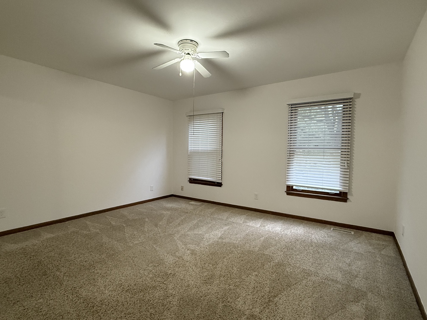 504 Old Hunt Road Fox River Grove, IL 60021 - Photo 11 of 12 an empty room with chandelier fan and windows
