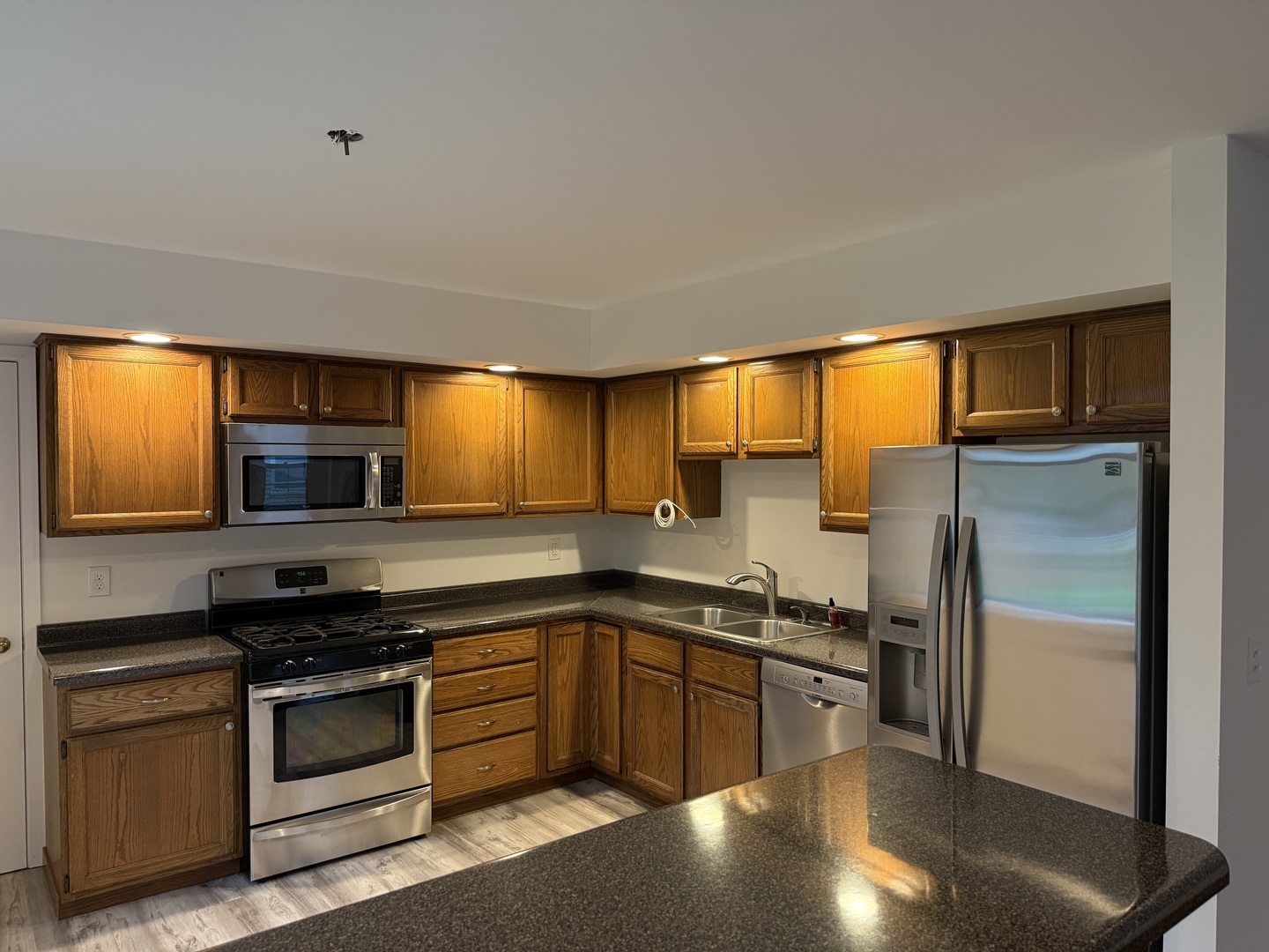 504 Old Hunt Road Fox River Grove, IL 60021 - Photo 3 of 12 a kitchen with stainless steel appliances a stove sink and microwave