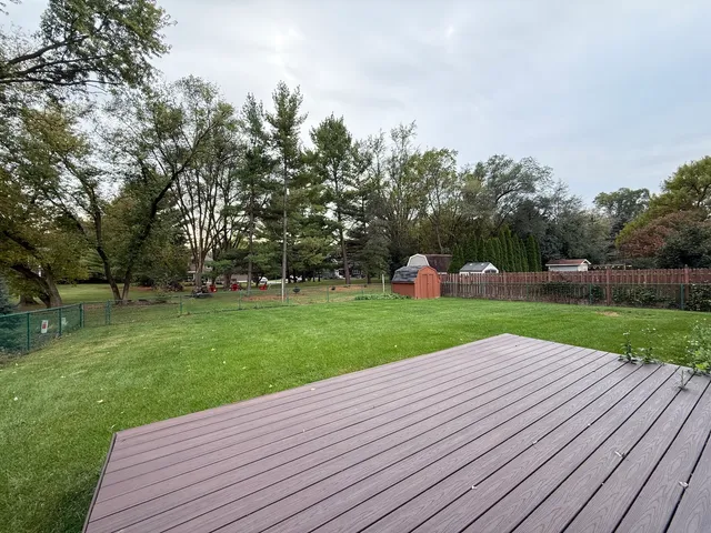 an empty room with wooden floor and entrance