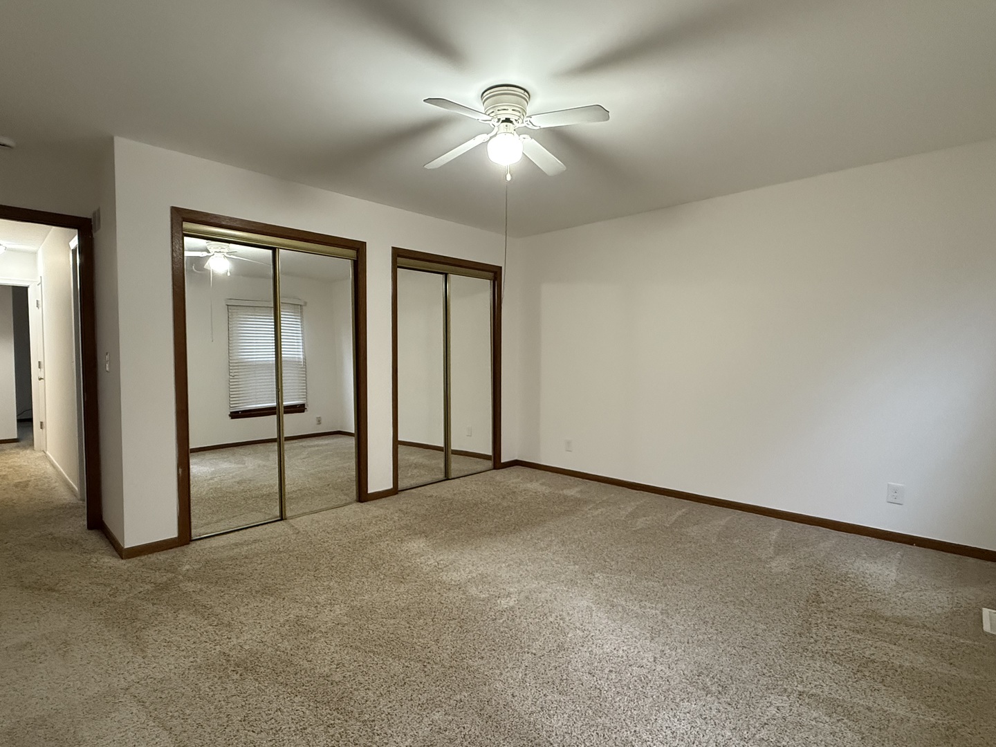 504 Old Hunt Road Fox River Grove, IL 60021 - Photo 10 of 12 an empty room with chandelier fan and windows