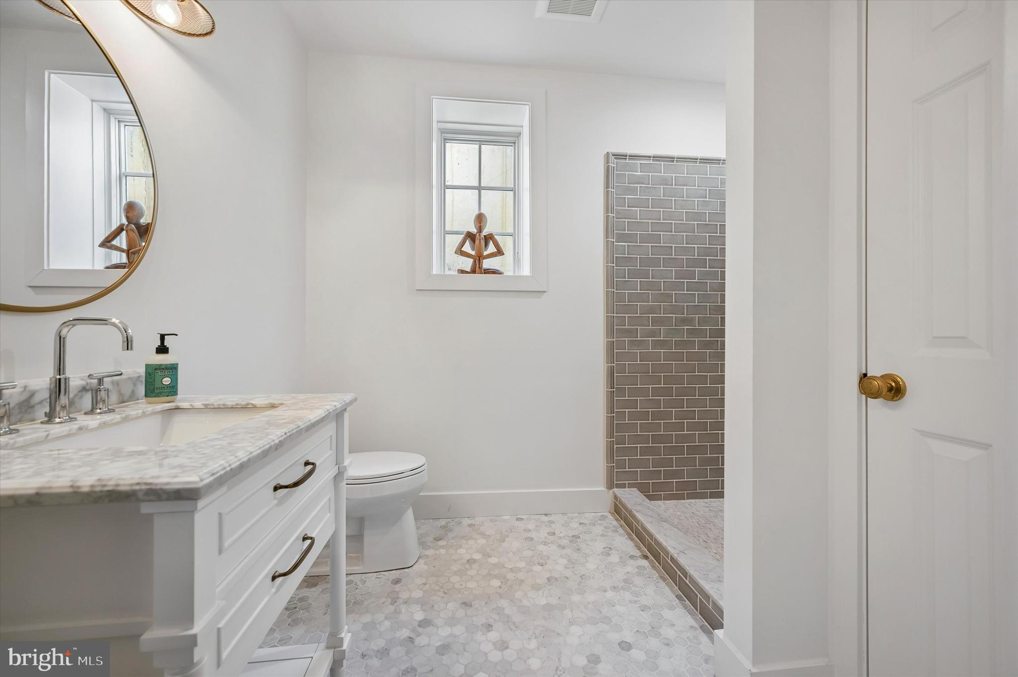 101 Hampton Lane Blue Bell, PA 19422 - Photo 49 of 68 a bathroom with a granite countertop sink a toilet and a mirror