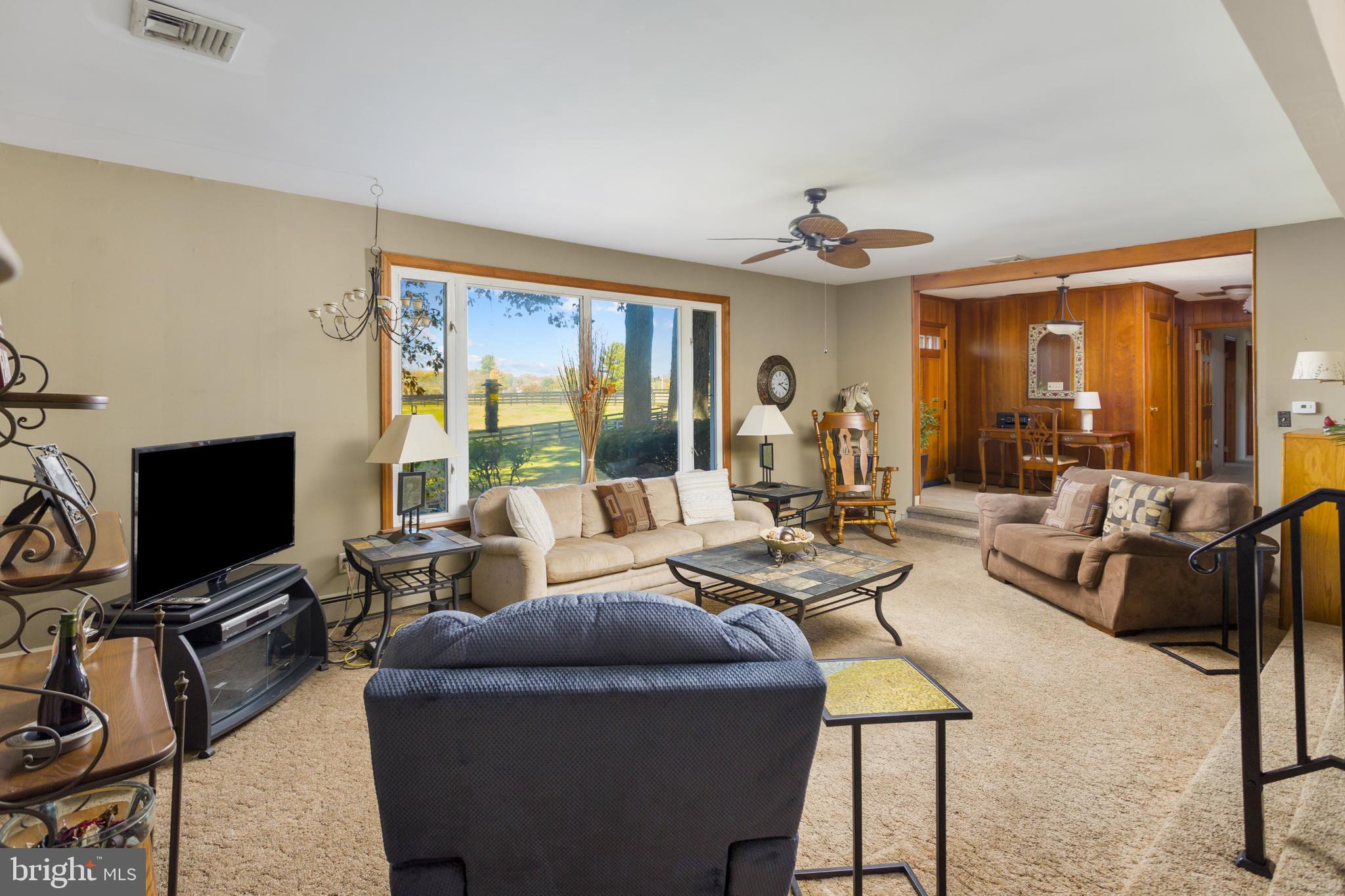 193 Burlington Path Road Cream Ridge, NJ 08514 - Photo 12 of 51 a living room with furniture a ceiling fan and a flat screen tv