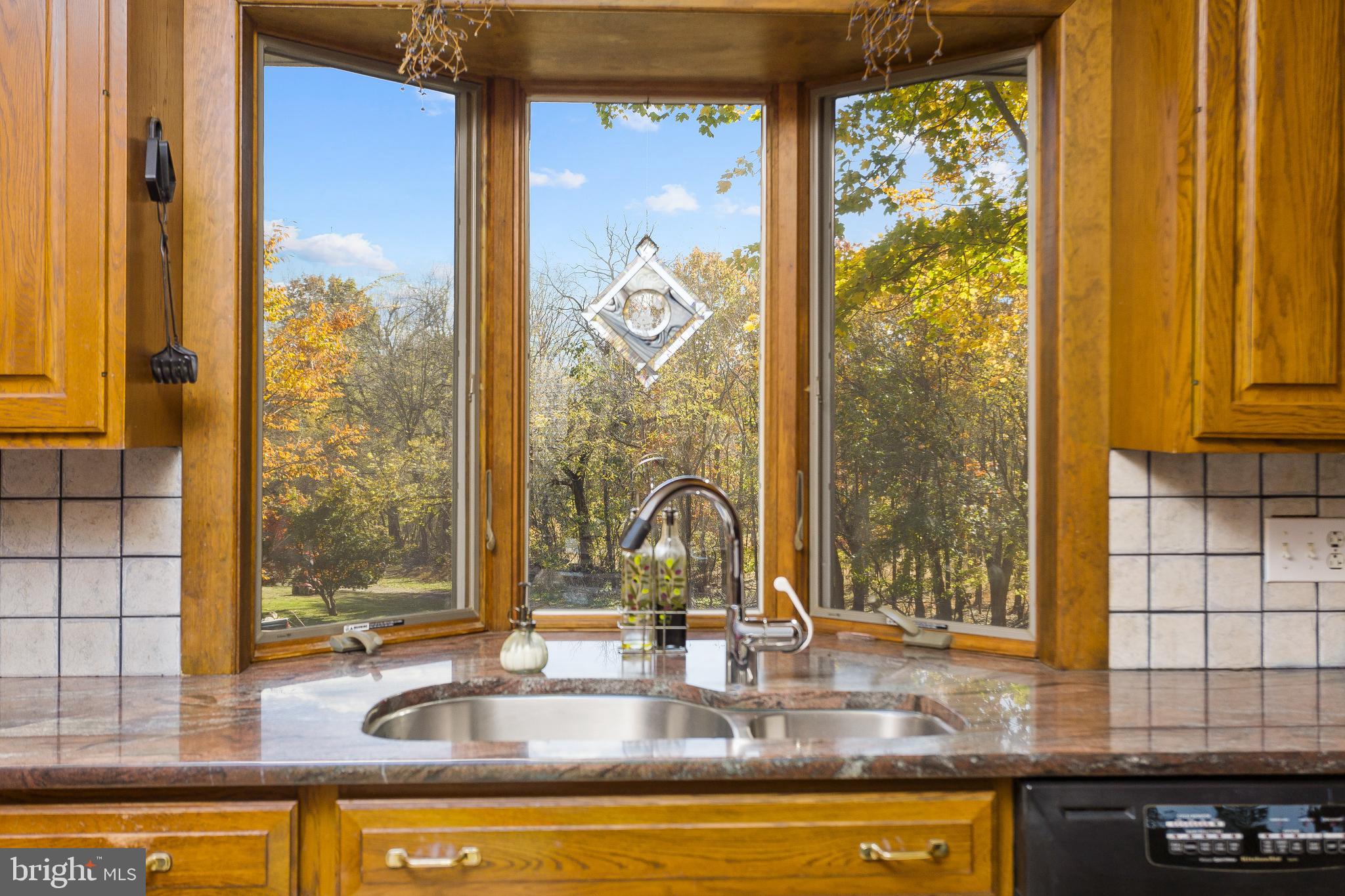 193 Burlington Path Road Cream Ridge, NJ 08514 - Photo 16 of 51 a view of a kitchen with kitchen island granite countertop a window and a sink