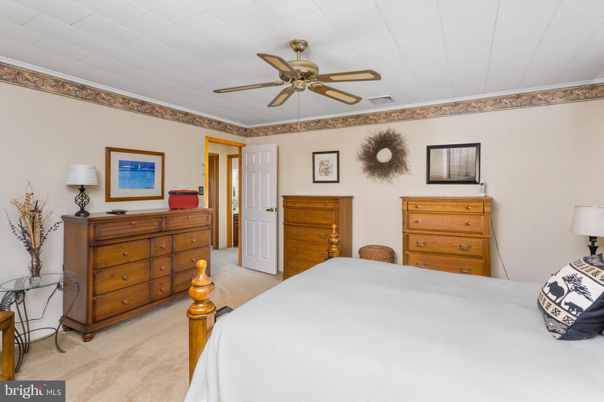 193 Burlington Path Road Cream Ridge, NJ 08514 - Photo 22 of 51 a bedroom with a bed and a chandelier