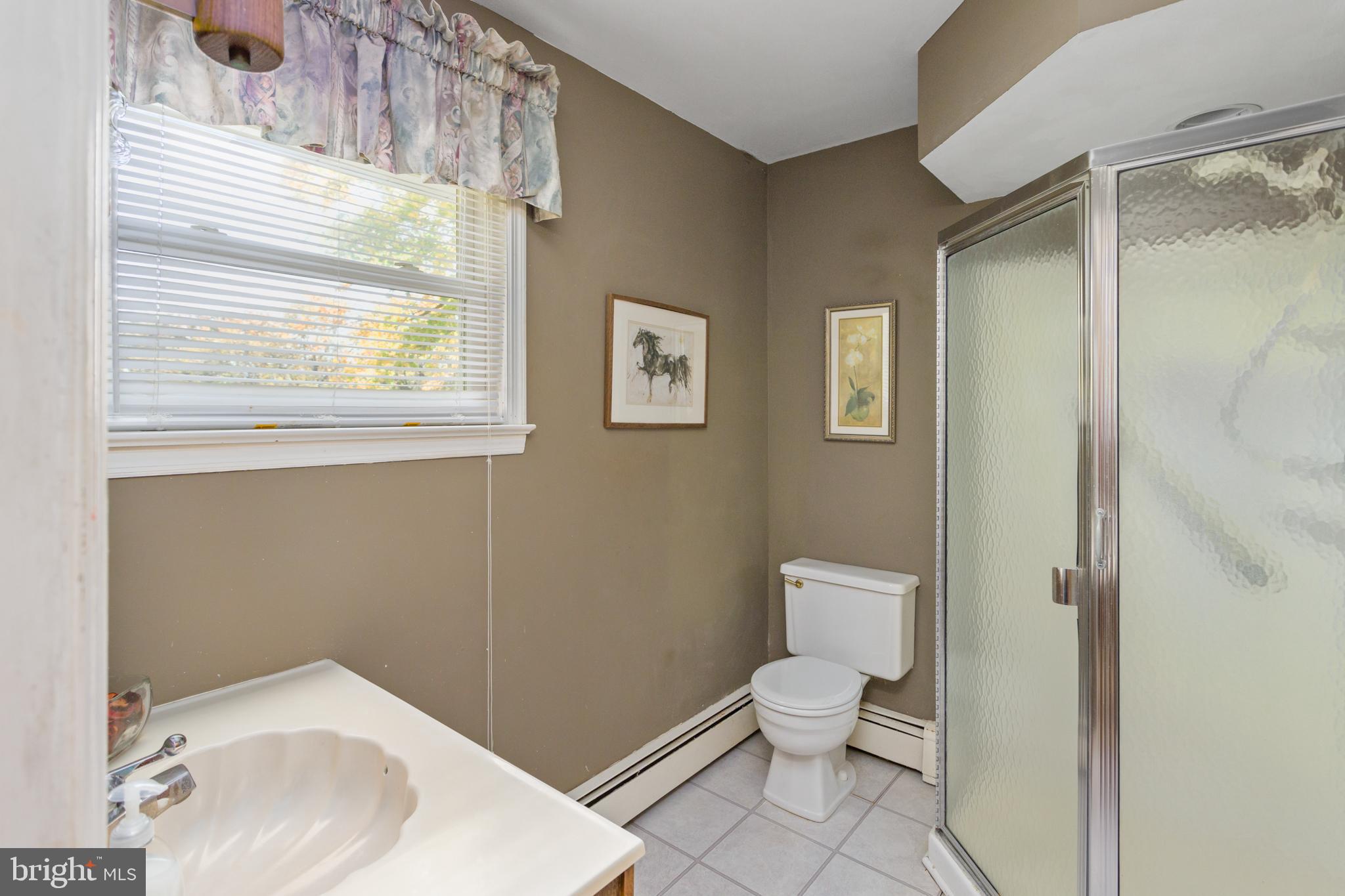 193 Burlington Path Road Cream Ridge, NJ 08514 - Photo 23 of 51 a bathroom with a toilet a sink and a window