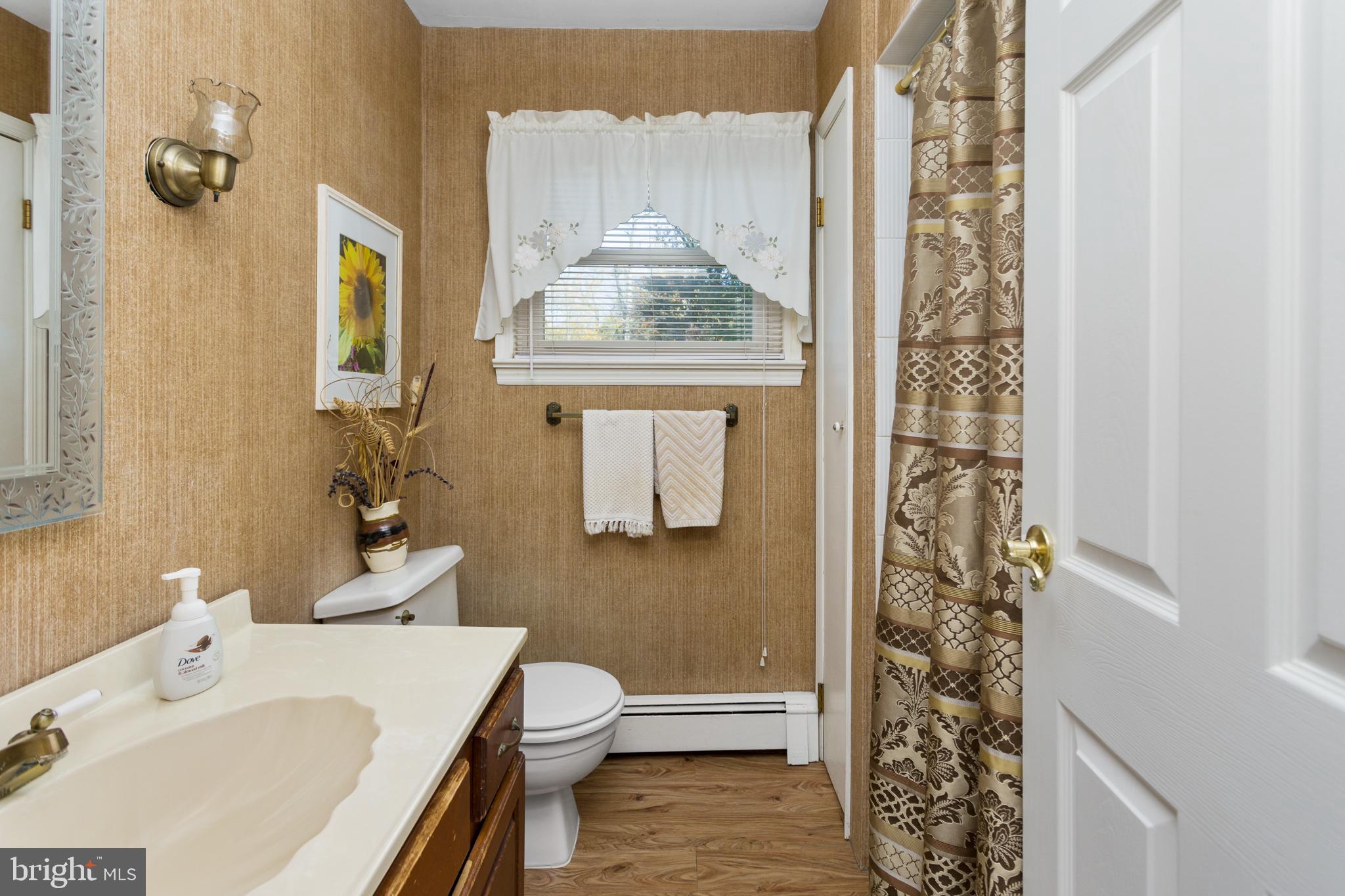 193 Burlington Path Road Cream Ridge, NJ 08514 - Photo 25 of 51 a bathroom with a sink a toilet and shower curtain