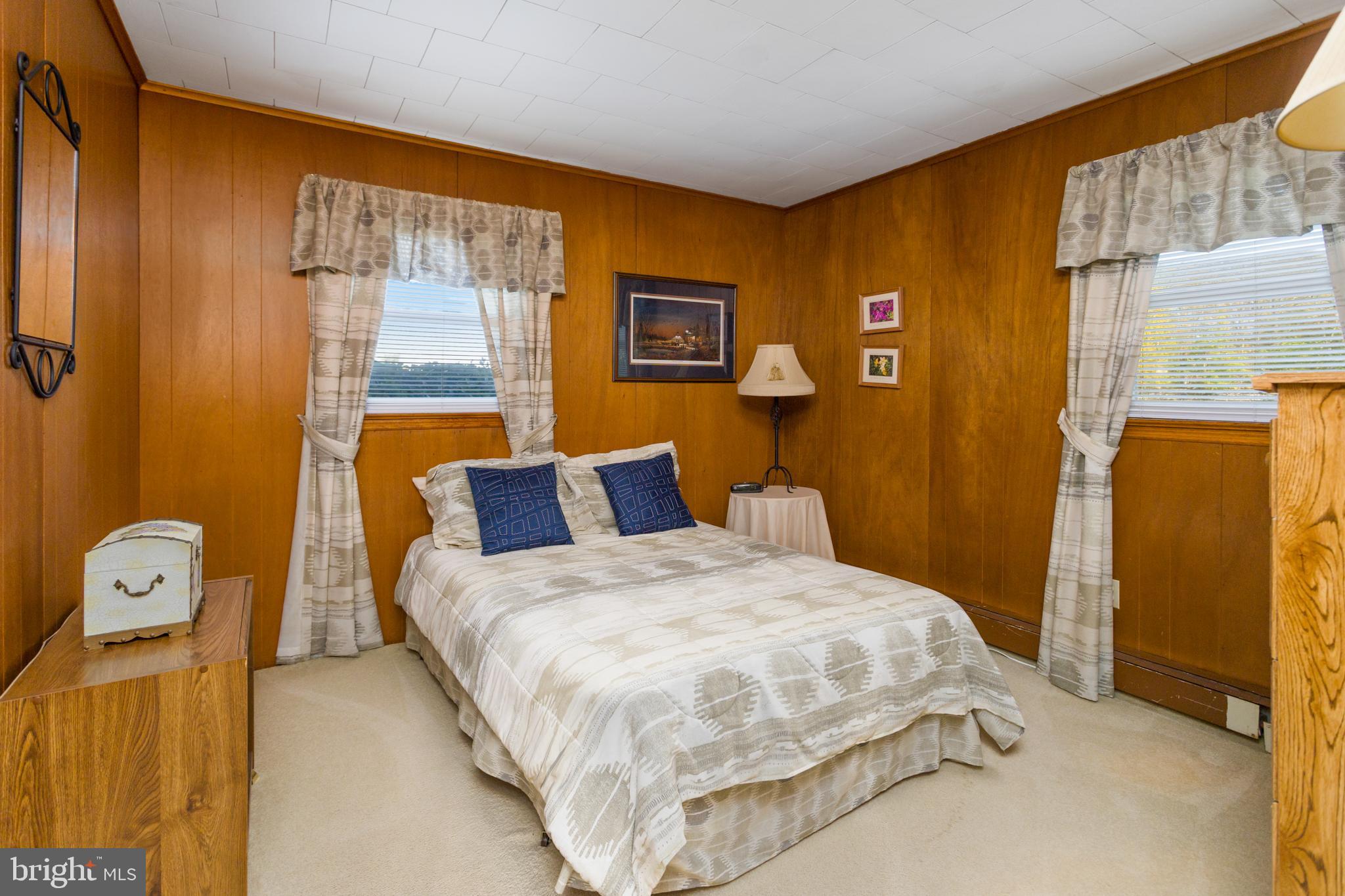 193 Burlington Path Road Cream Ridge, NJ 08514 - Photo 26 of 51 a bedroom with a bed and wooden floor