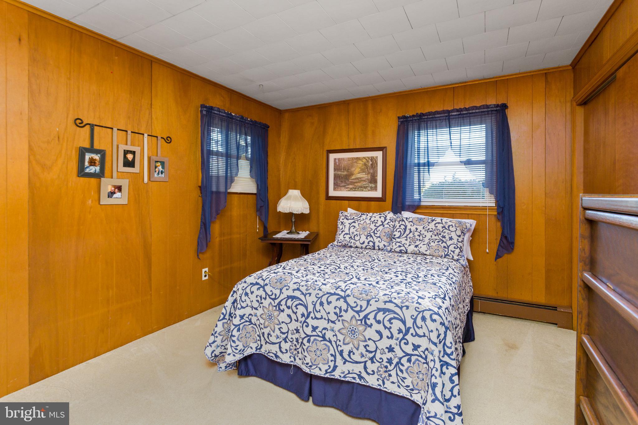 193 Burlington Path Road Cream Ridge, NJ 08514 - Photo 28 of 51 a bedroom with a bed and wooden floor