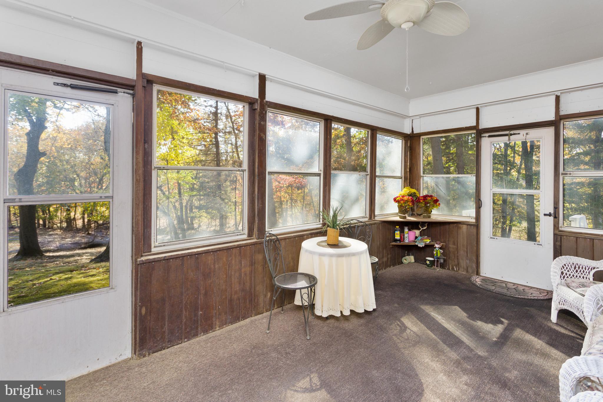 193 Burlington Path Road Cream Ridge, NJ 08514 - Photo 31 of 51 a living room with furniture and a floor to ceiling window