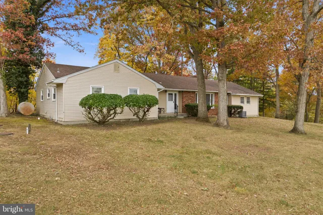 a front view of a house with a garden and yard