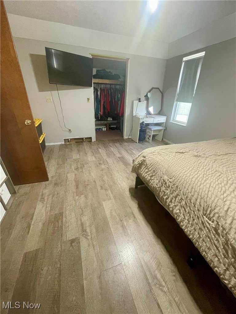 7990 Quarry Road Amherst, OH 44001 - Photo 14 of 29 Bedroom featuring wood-type flooring and a closet