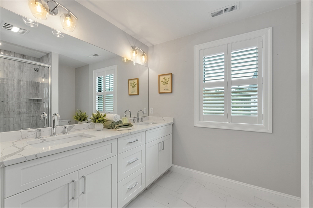 2 Brownson Terrace Boston, MA 02130 - Photo 20 of 30 a spacious bathroom with a granite countertop sink mirror and next to a window