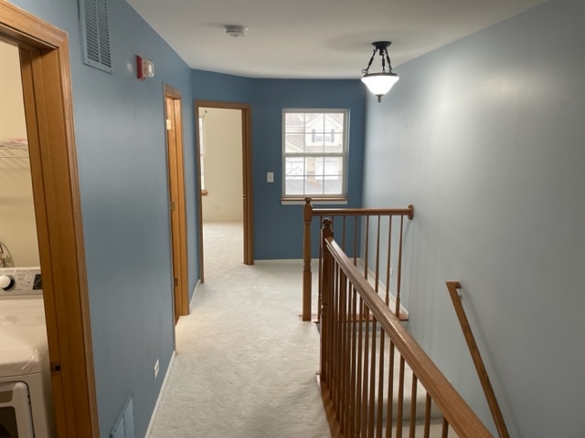 2439 Oneida Lane Naperville, IL 60563 - Photo 8 of 15 a view of hallway with stairs and chandelier