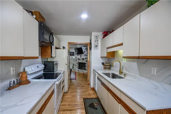 a living room with furniture a floor to ceiling window and a rug